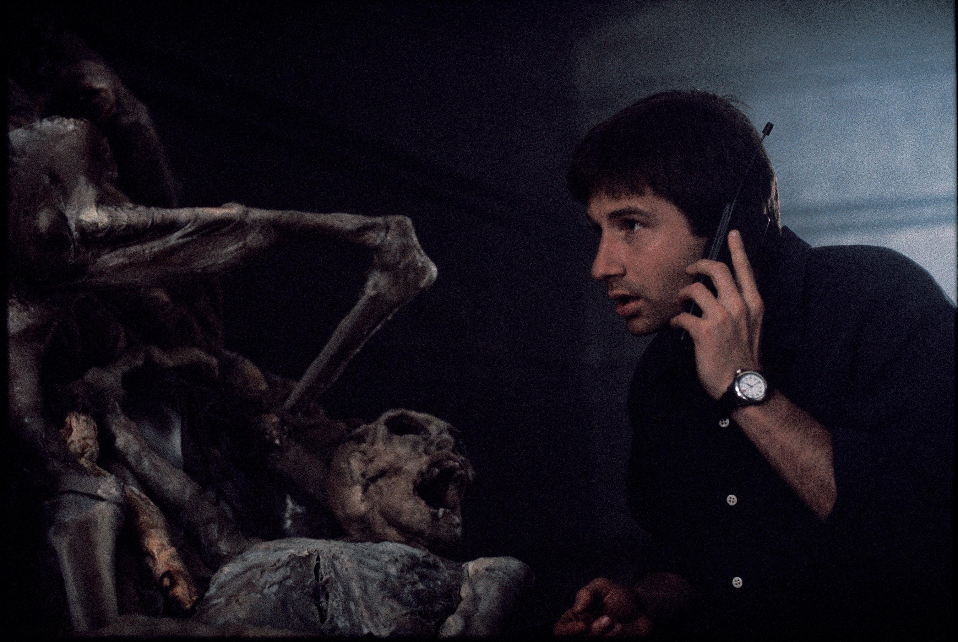 Mulder inspects evidence of an alien conspiracy.