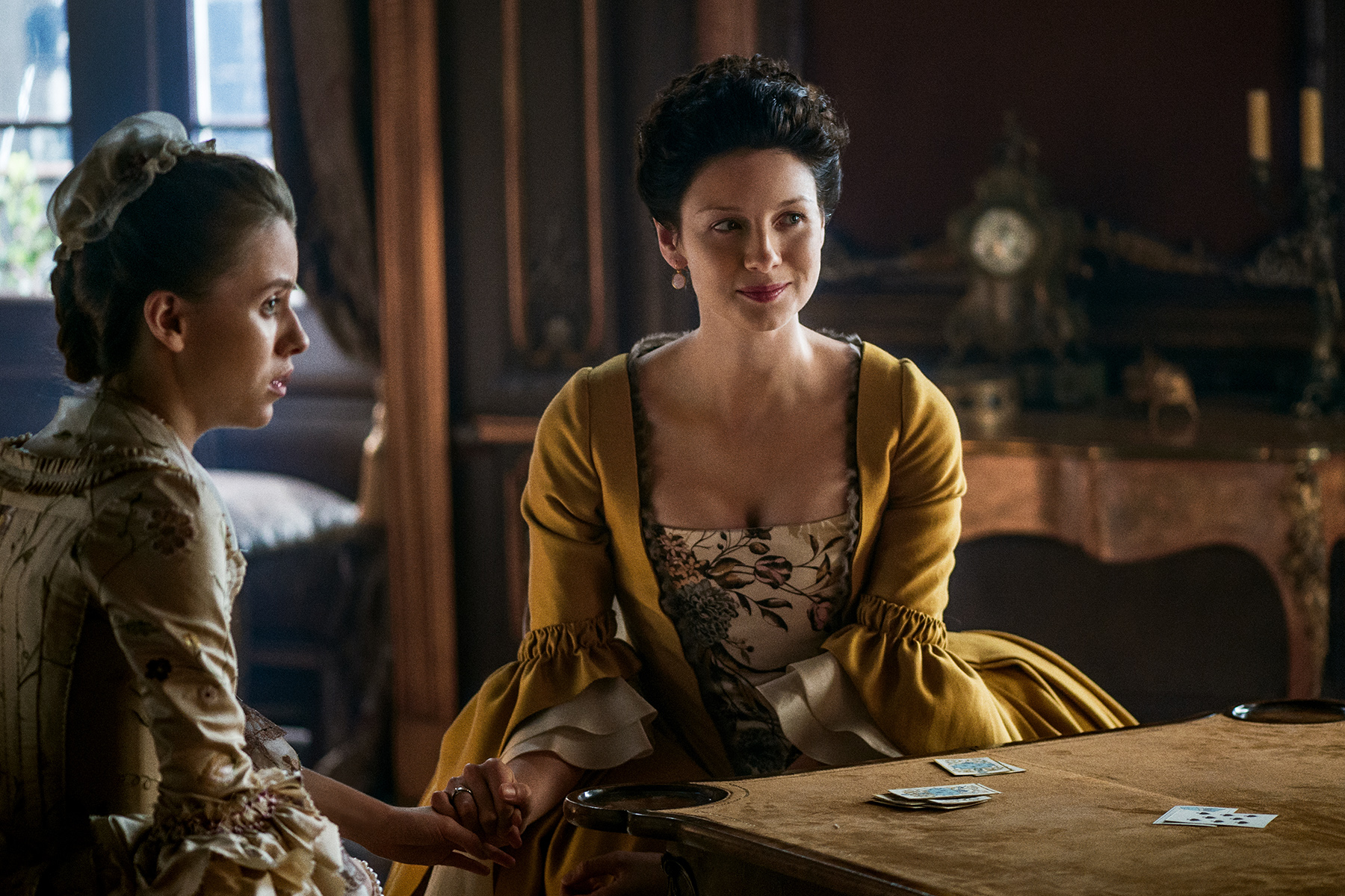 Claire sitting with Mary King. Sadly, I don't think Claire (Caitriona Balfe) is going to get out of this one by playing an electric guitar.
