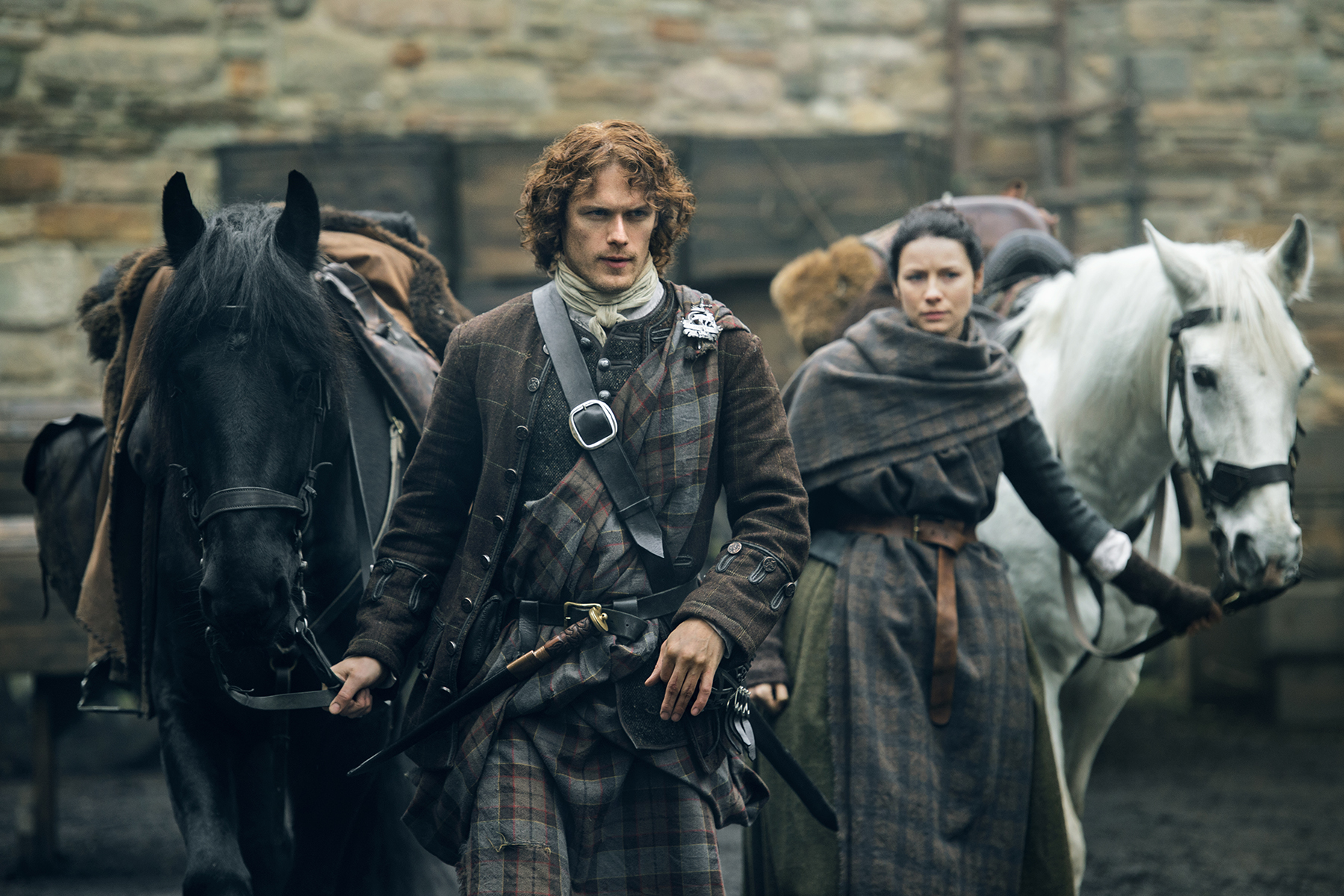 Jamie and Claire heading out of Lord Lovat's with their horses. Y'all with your witch-y business gonna get yourselves killed.