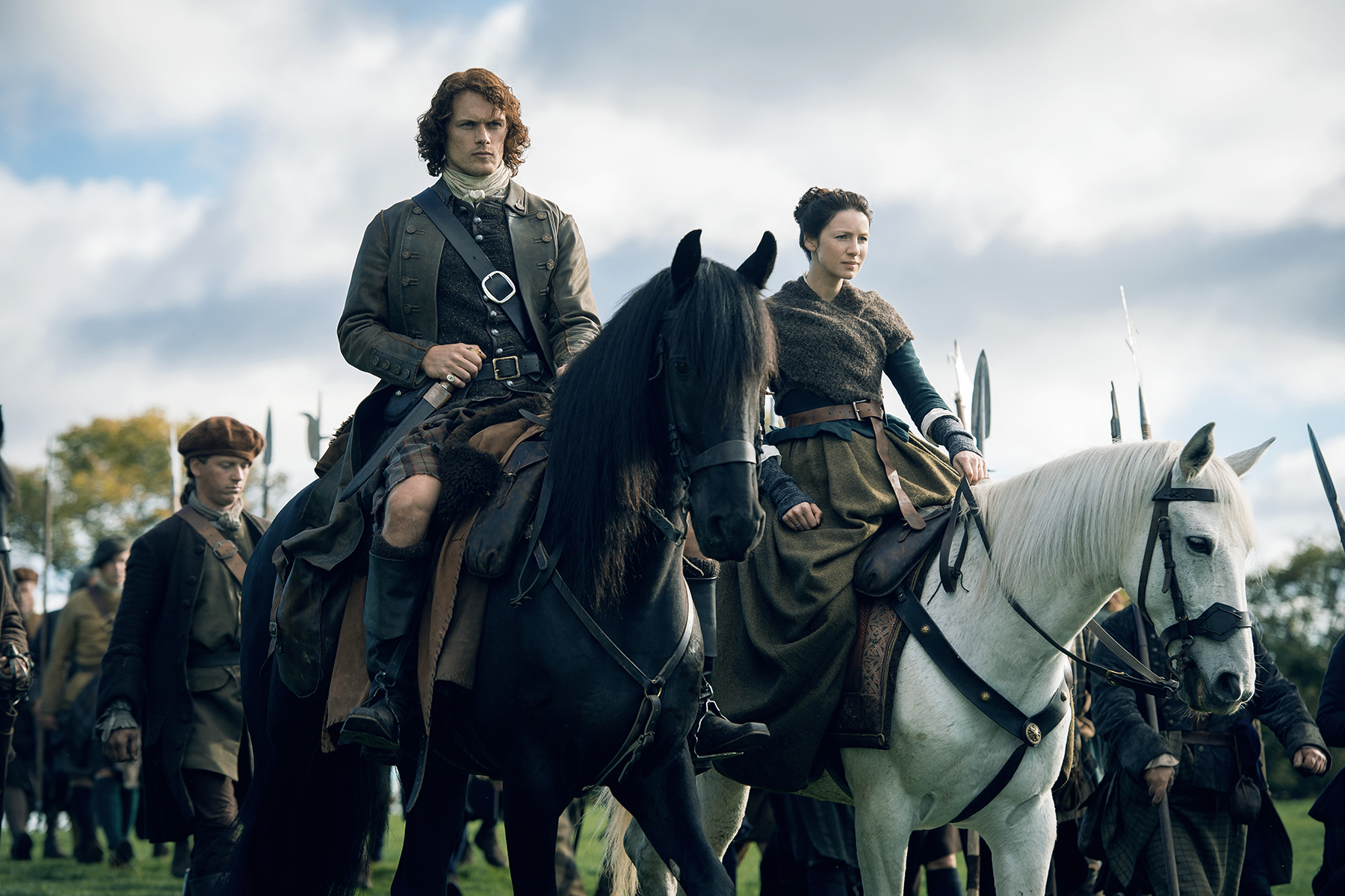 Claire and Jamie astride beautiful horses, in front of the Fraser army. They are throwing off Power Couple vibes form here to the Moon.
