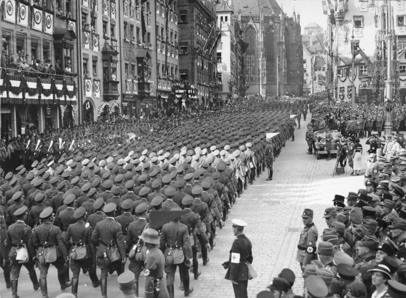 Nazi soldiers march past Hitler in the 1934 propoganda film, Triumph of the Will. [Courtesy Wikimedia Commons.]